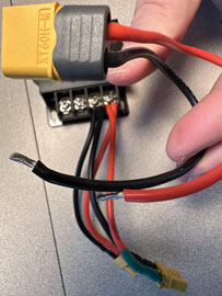 A hand holding a wire to a device

AI-generated content may be incorrect.