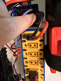 A hand holding a yellow and black device

AI-generated content may be incorrect.