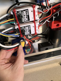 A hand holding wires and wires

AI-generated content may be incorrect.