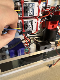 A hand holding wires to a machine

AI-generated content may be incorrect.