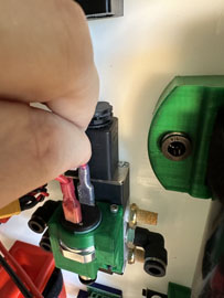 A person's finger on a green device

AI-generated content may be incorrect.