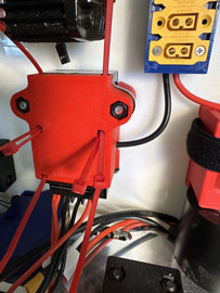 A red box with black wires

AI-generated content may be incorrect.